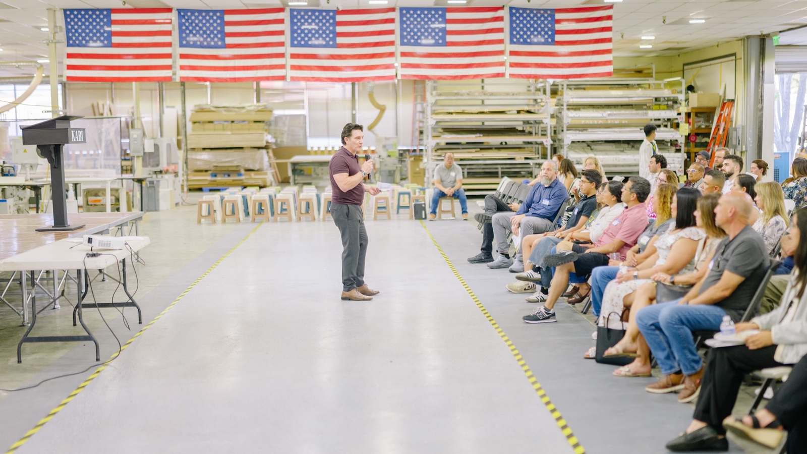 Speaker presenting to guests inside the factory